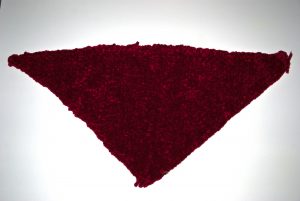Dark red piece woven on a triangular loom