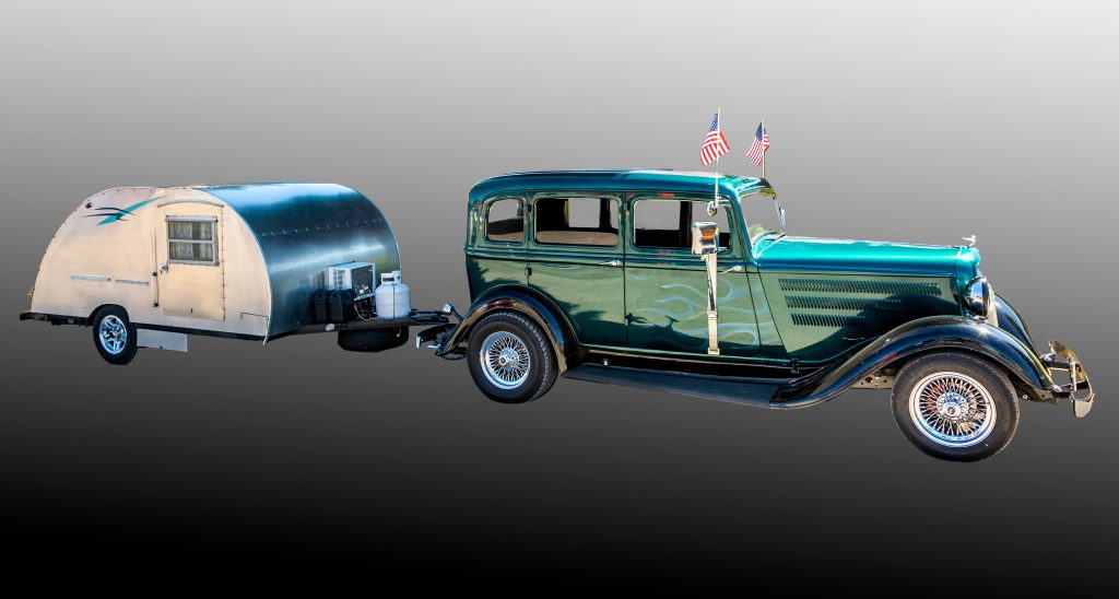 A 1933 Plymouth with a teardrop trailer