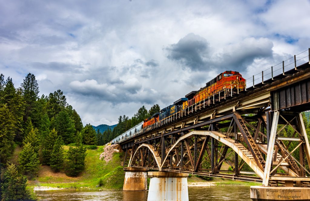 A photo of a BNSF grain train crossing the Clark Fork River