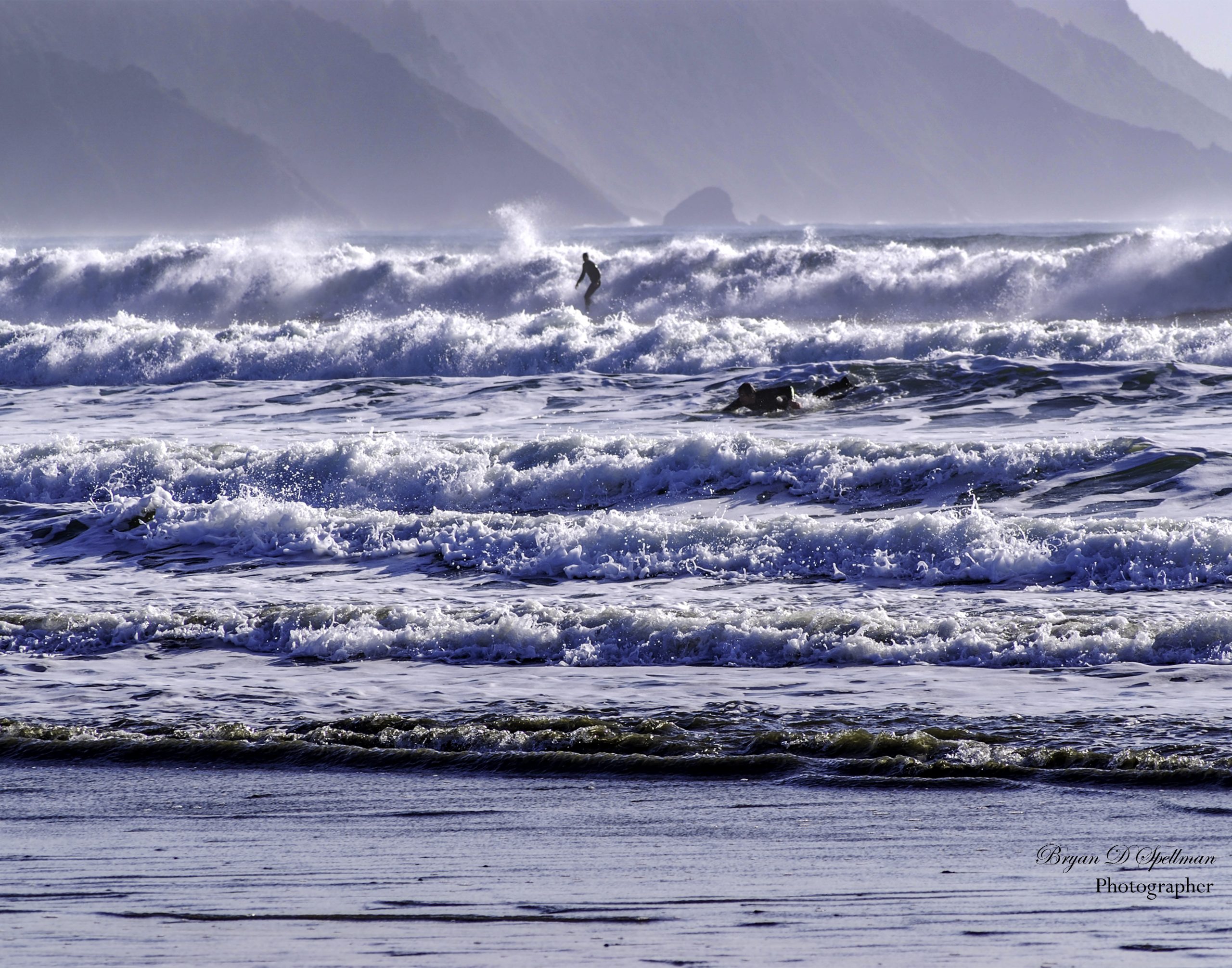Two surfers braving the waves on a January day in northern California