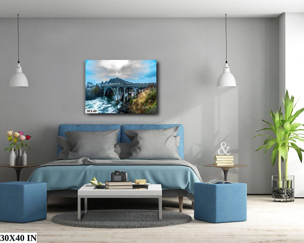 A 30x40" stretched canvas print hanging above a king-sized bed