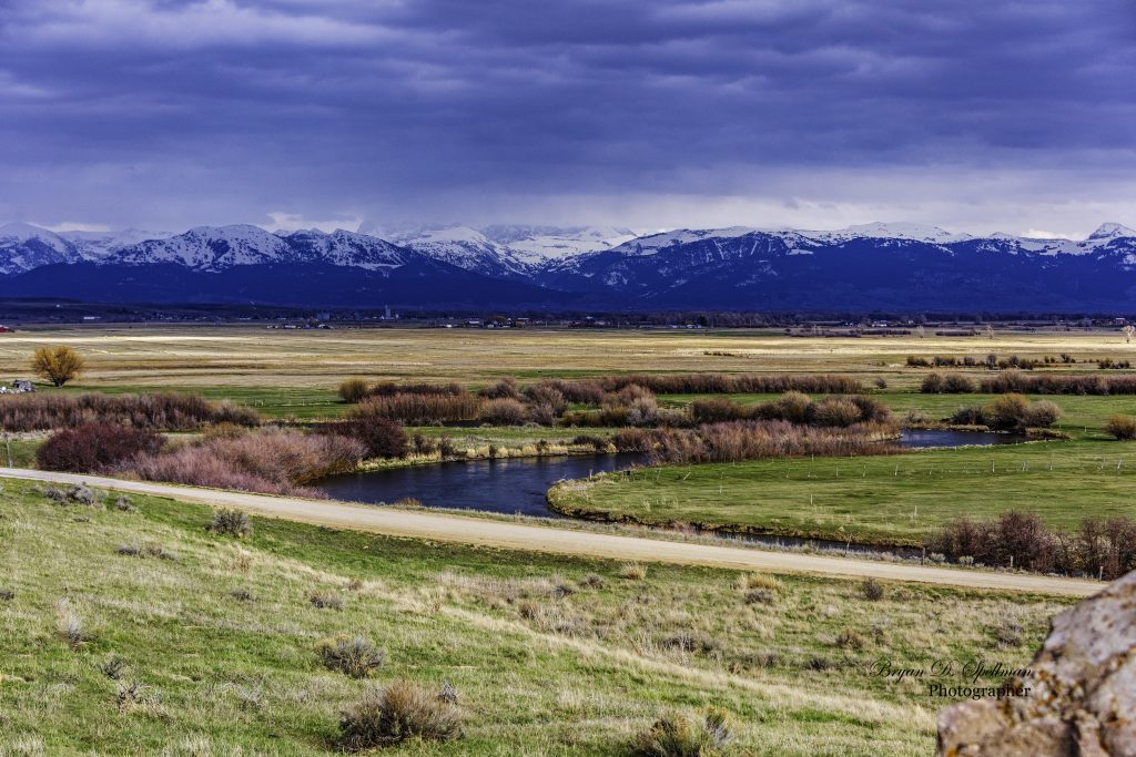The Teton River with the Teton Mountains in the background.  The river cuts through the center of Teton County.